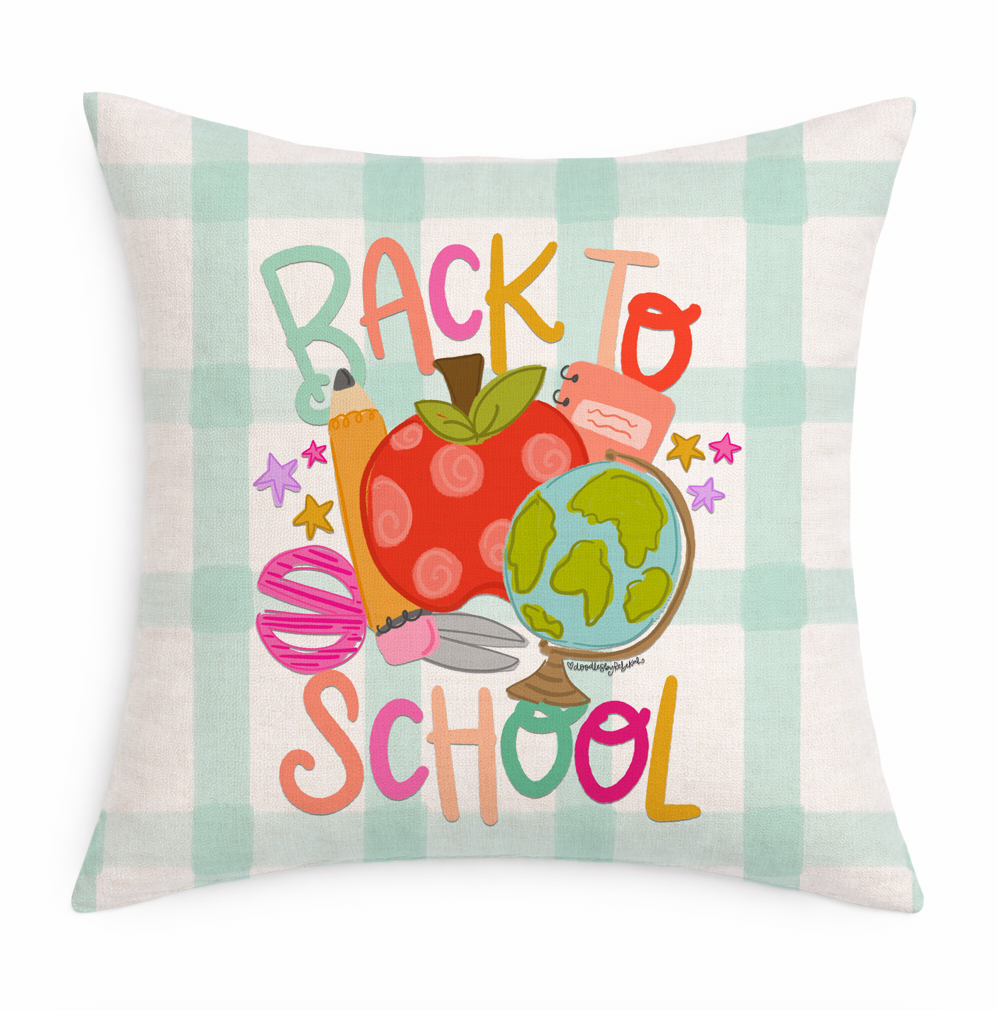 Decorative pillow with 'Back to School' text and educational symbols on a plaid background