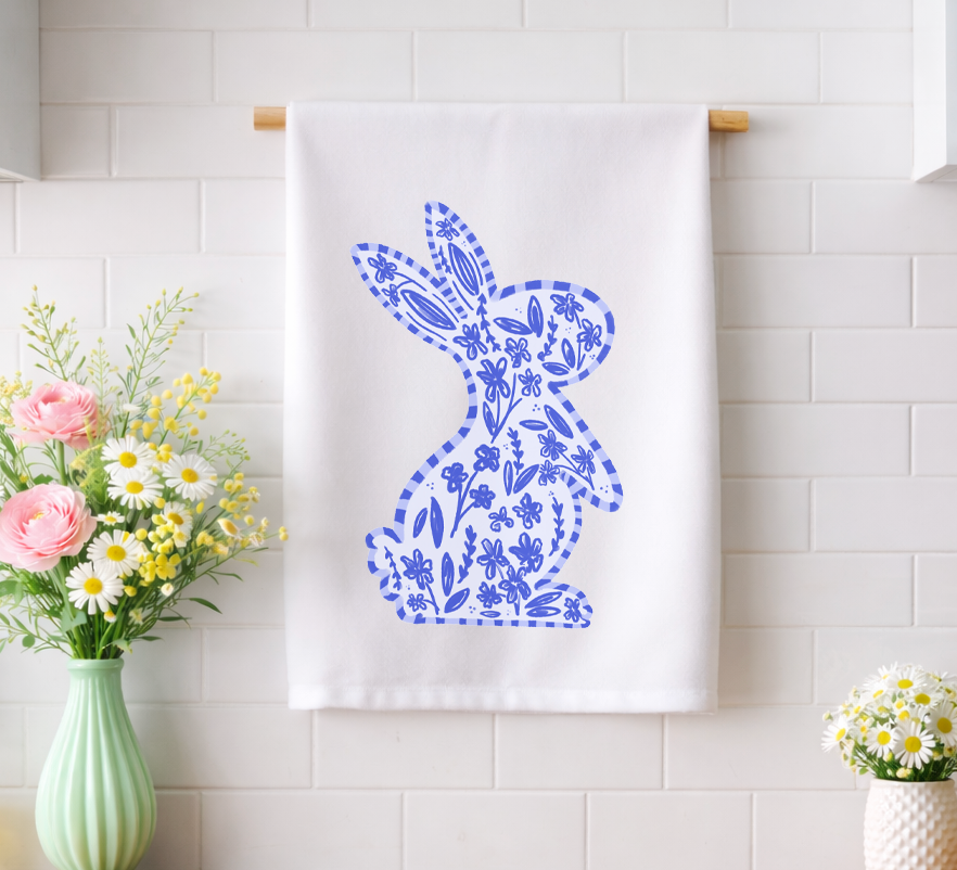 Chinoiserie-inspired blue and white floral bunny kitchen tea towel displayed in a bright spring kitchen with fresh flowers.