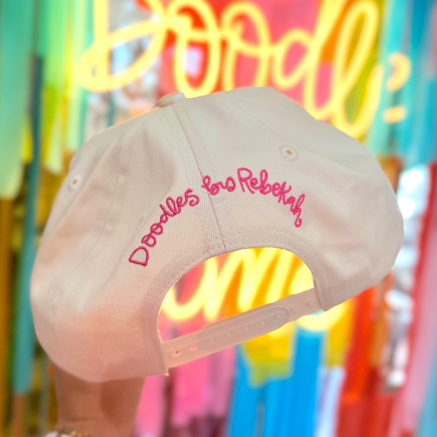 Doodles Upside Down Embroidered Hat With Decorative Bill back on a colorful background