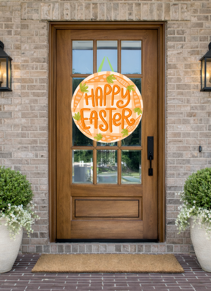 Doodles by Rebekah "Happy Easter" door decor featuring a whimsical orange gingham and carrot-themed illustration on a rustic front porch.