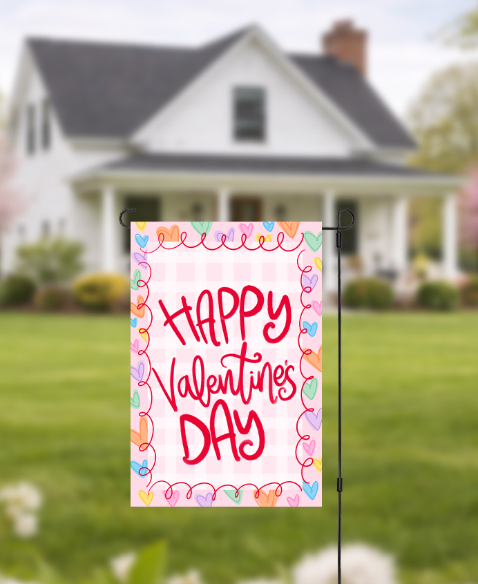 Doodles by Rebekah "Happy Valentine's Day" garden flag featuring whimsical red hand-painted typography and a pink checkered pattern. This cheerful outdoor holiday decor is perfect for Valentine's Day celebrations or adding a touch of love to front yard landscaping.