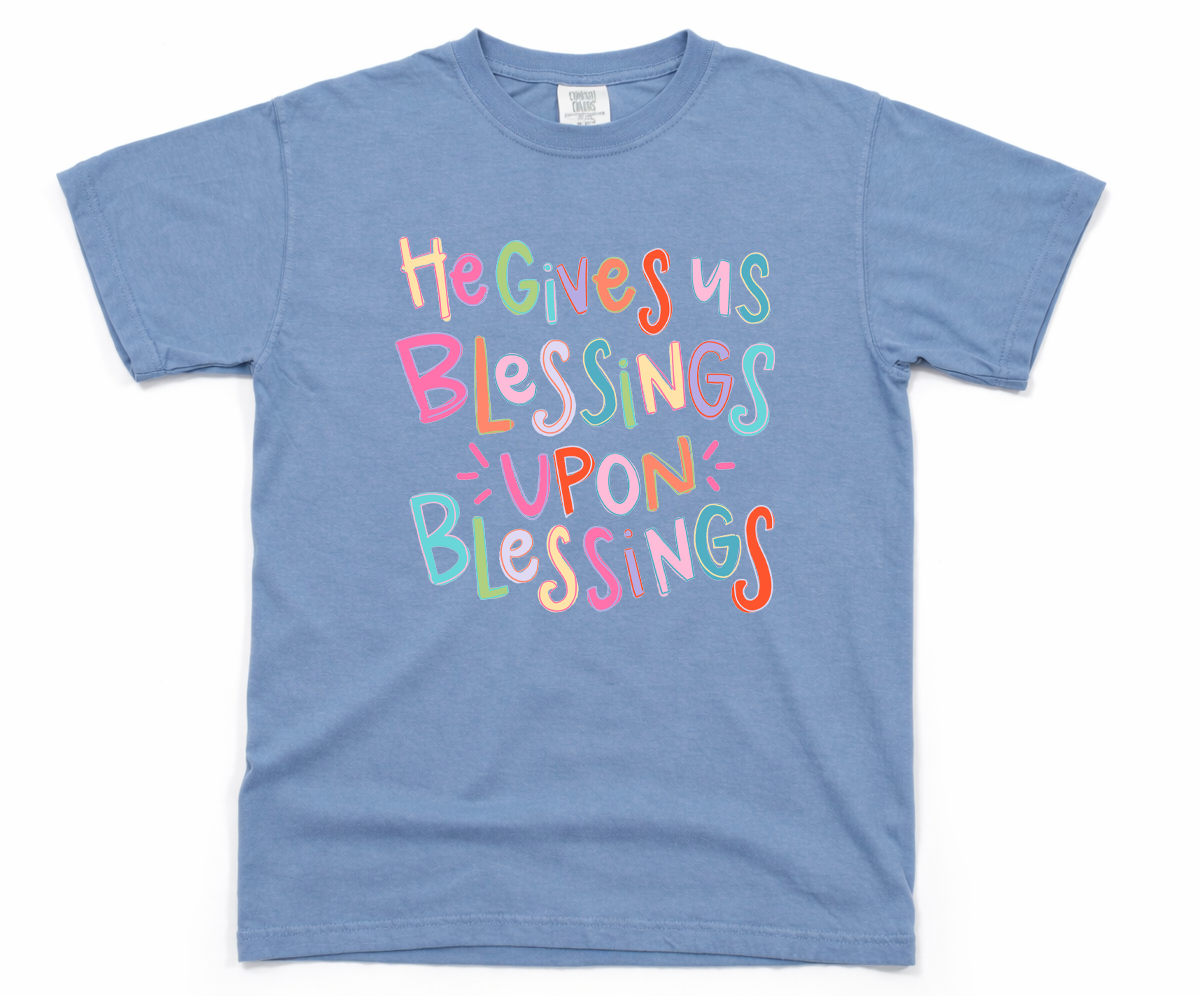 Blue t-shirt with colorful text design on a white background