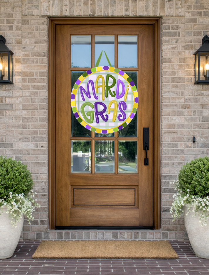 Doodles by Rebekah "Mardi Gras" door decor featuring a whimsical hand-painted design with a green gingham background and traditional carnival colors on a rustic front porch.