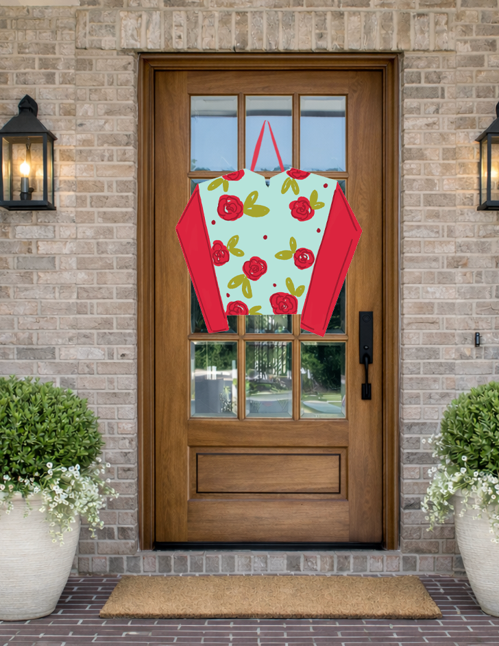Doodles by Rebekah Kentucky Derby horse racing decor featuring a whimsical red rose patterned jockey silk door hanger on a rustic front porch.