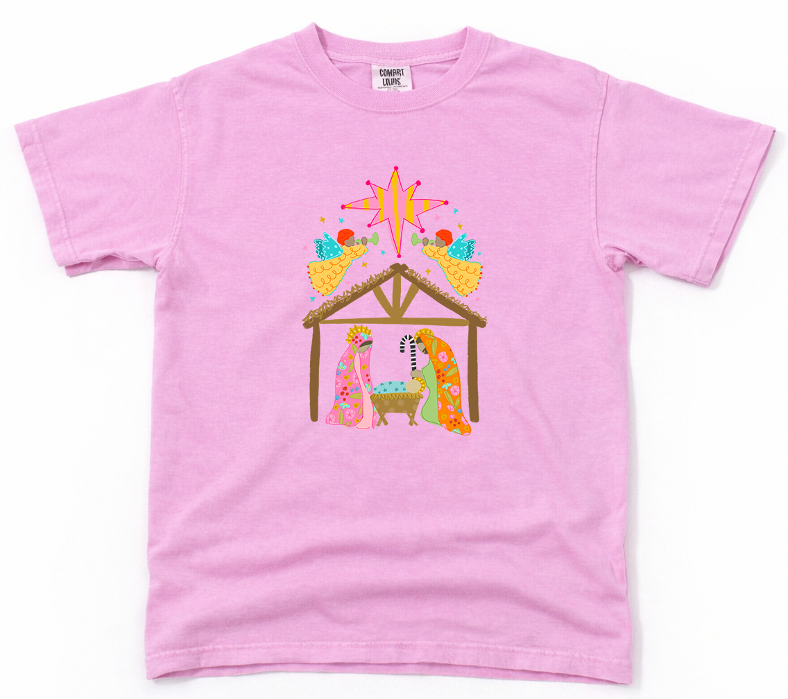 Pink t-shirt with a nativity scene design on a white background