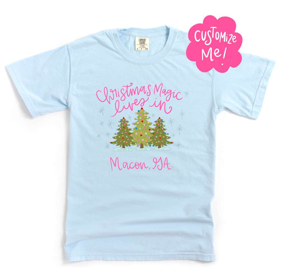 Light blue t-shirt with Christmas-themed design and 'Customize Me!' text on a white background