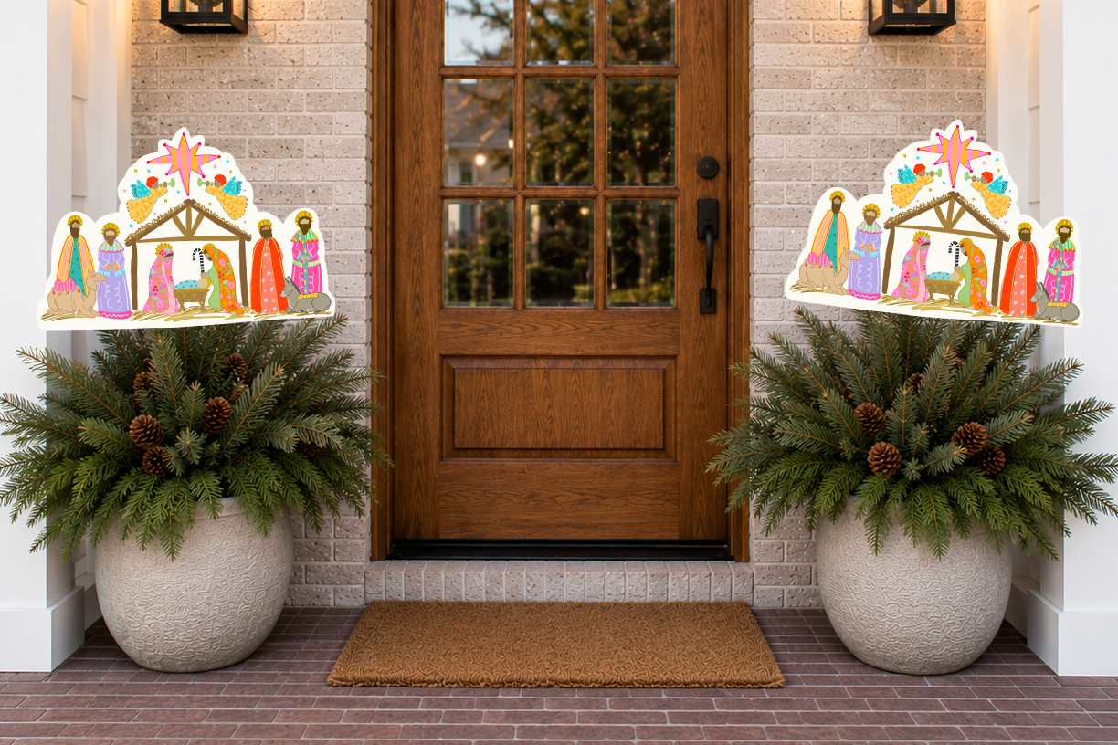 Decorative nativity scene on planters outside a house entrance.