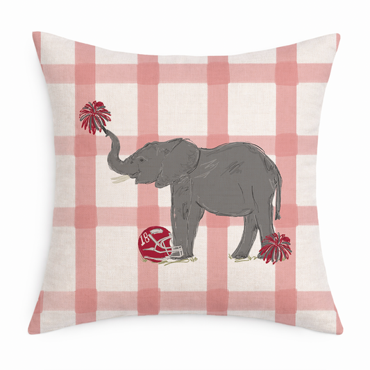 Decorative pillow with an elephant holding a football and pom-poms on a pink and white checkered background.