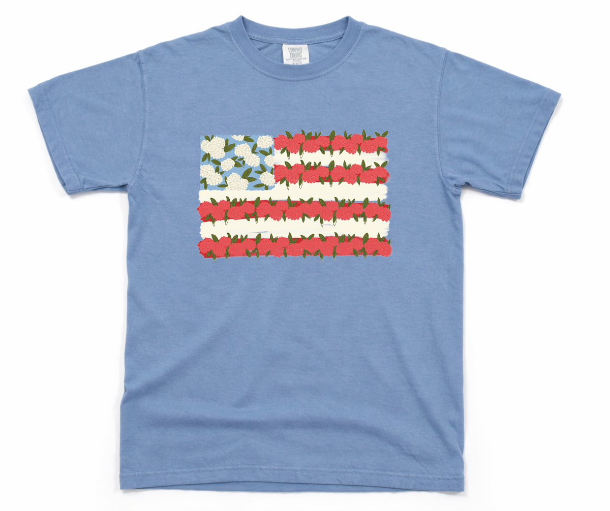 Blue t-shirt with a floral American flag design on a white background