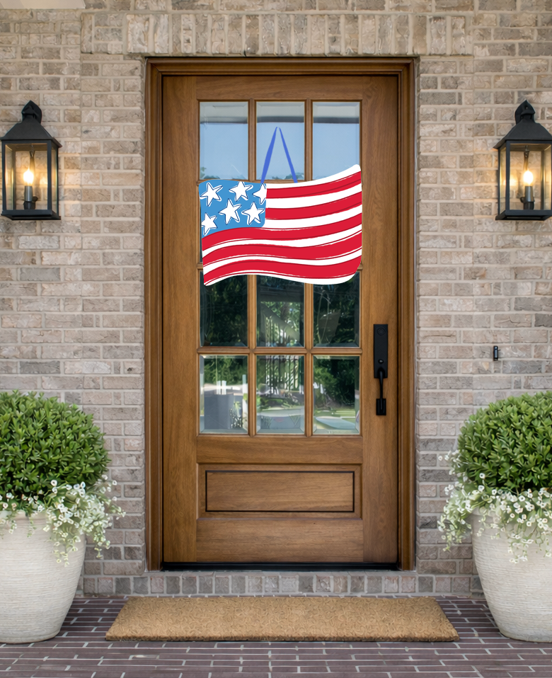 Doodles by Rebekah patriotic American flag door decor featuring a hand-drawn wavy flag illustration on a rustic front porch.