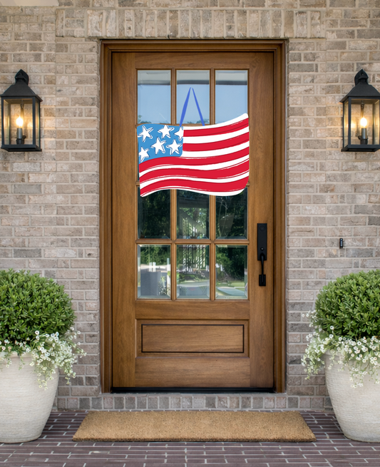 Doodles by Rebekah patriotic American flag door decor featuring a hand-drawn wavy flag illustration on a rustic front porch.