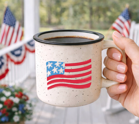 Doodles by Rebekah Americana flag campfire mug featuring a whimsical hand-painted US flag design. This patriotic ceramic coffee cup is ideal for 4th of July celebrations, Memorial Day decor, or as a gift for veterans and farmhouse style lovers.