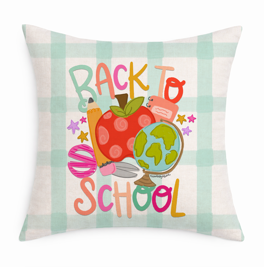 Decorative pillow with 'Back to School' text and educational symbols on a plaid background