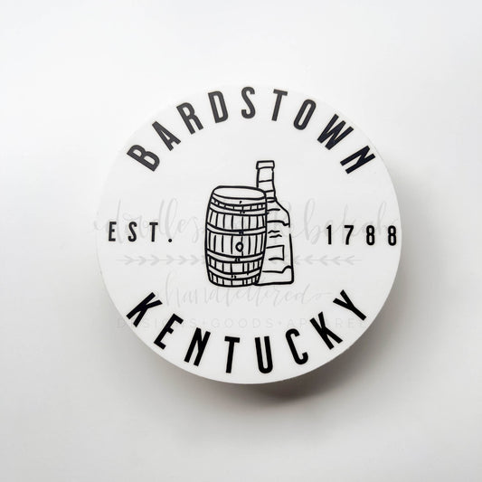 A round white sticker with the text 'BARDSTOWN KENTUCKY EST. 1788' and an illustration of a bourbon barrel.
