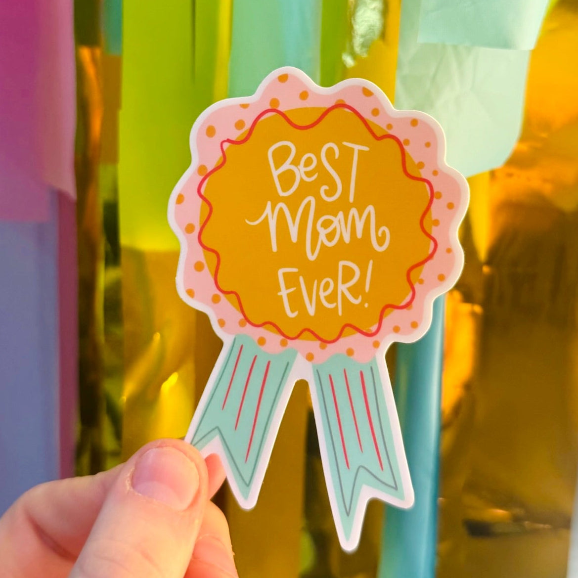 Doodles by Rebekah "Best Mom Ever!" award ribbon sticker. This hand-painted, whimsical vinyl decal is a perfect gift for mothers, ideal for decorating water bottles, laptops, or journals to celebrate a special mom.