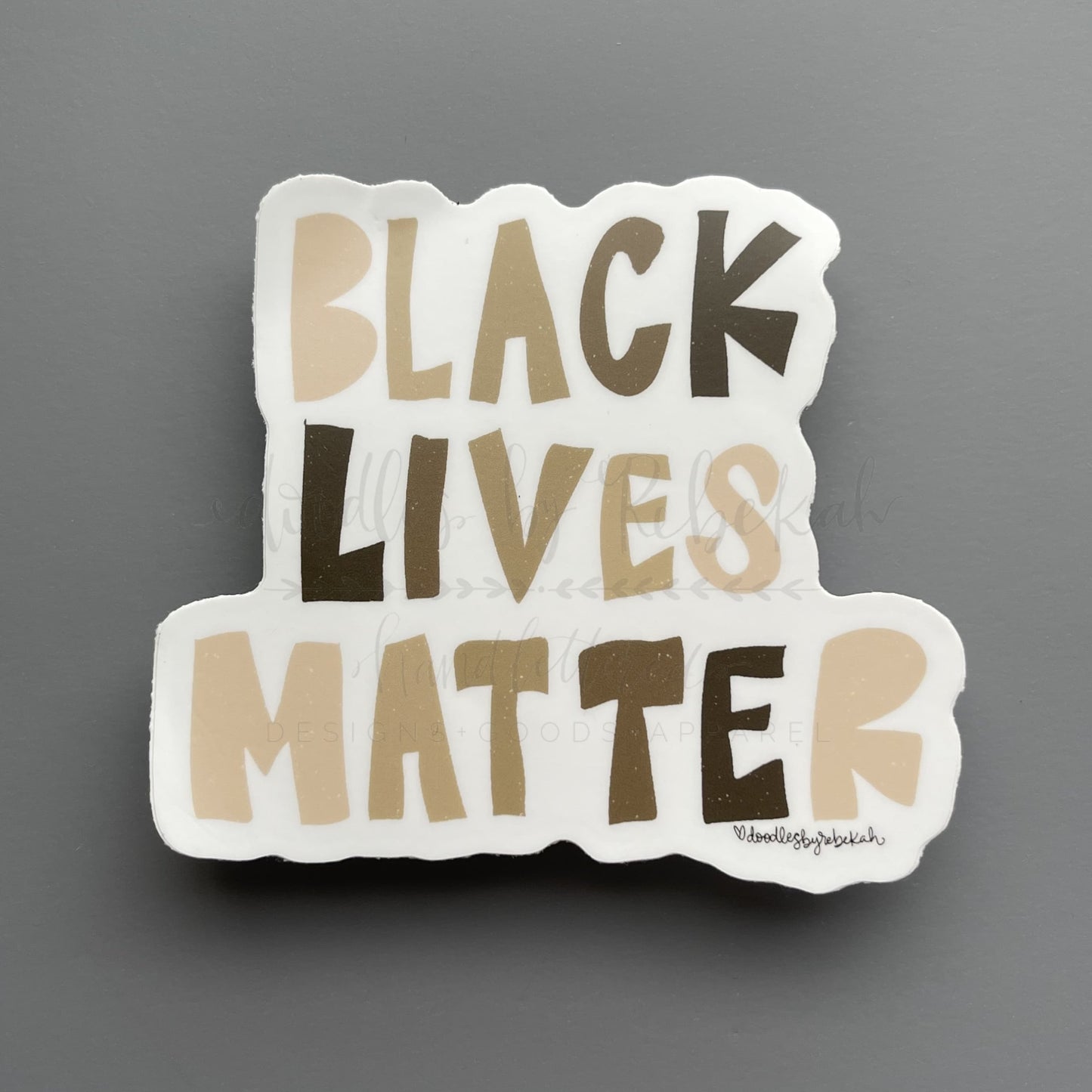 Black Lives Matter sticker with whimsical earth-tone typography and hand-lettered block letters, ideal for social justice advocacy and laptop decoration.