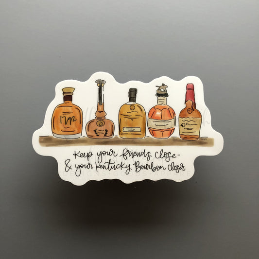 A sticker with an illustration of bourbon bottles and the text 'Keep your friends close & your bourbon closer'.
