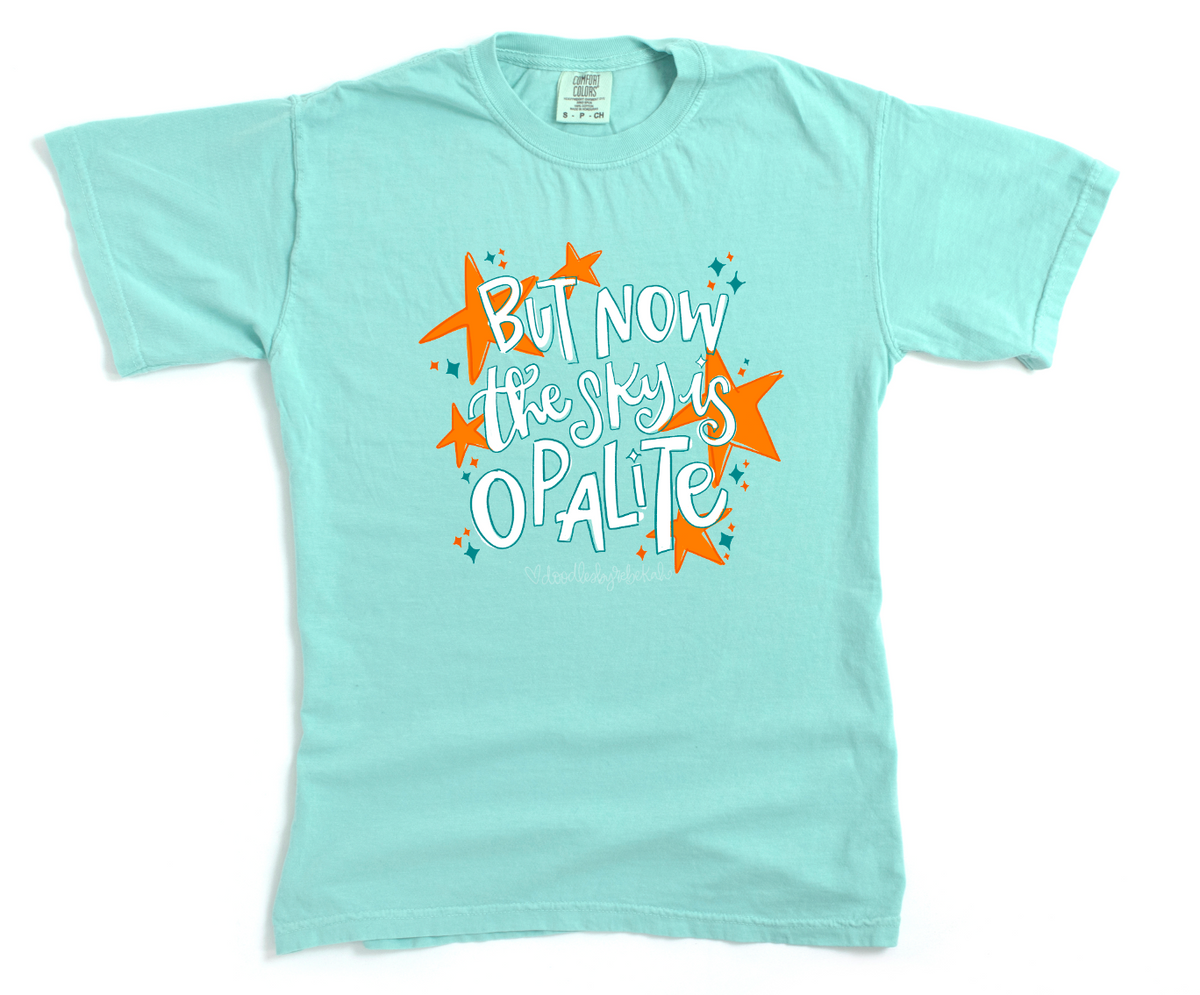 Light blue t-shirt with colorful text and star graphics on a white background