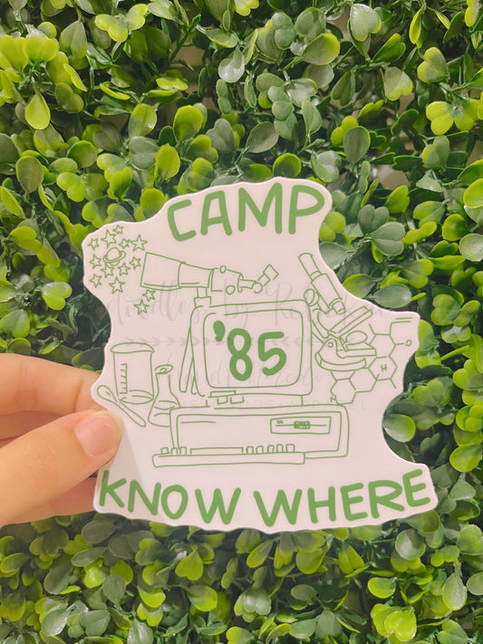 A white die cut sticker that reads "Camp Know Where '85" with a science based sketch