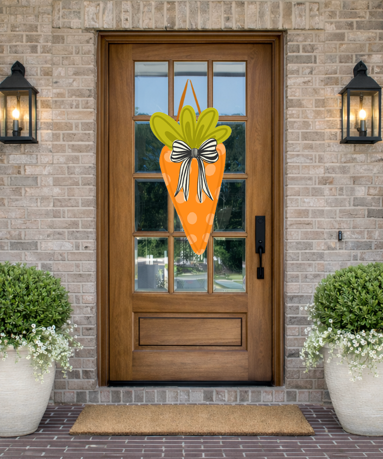 Doodles by Rebekah spring door decor featuring a whimsical hand-drawn polka dot carrot illustration with a striped bow, displayed on a rustic front porch.
