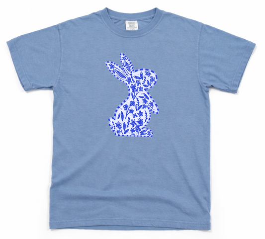 Blue t-shirt with a white floral bunny design on a white background