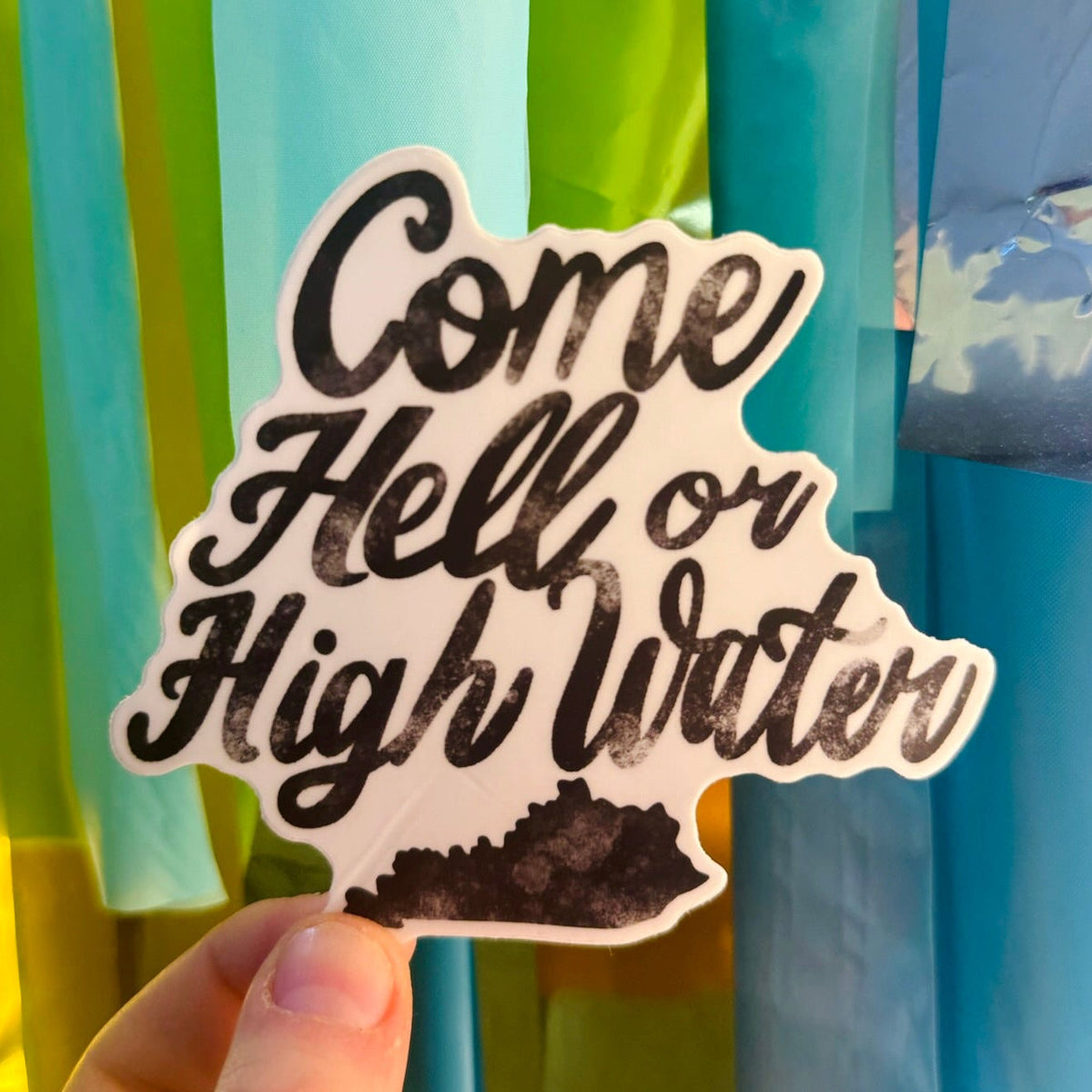 Doodles by Rebekah "Come Hell or High Water" Kentucky quote sticker. This whimsical hand-painted vinyl decal features a motivational southern phrase and a Kentucky state silhouette, making it a perfect gift for KY residents to decorate water bottles, laptops, and journals.
