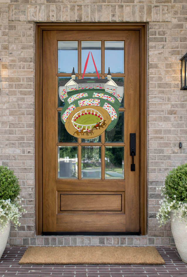 Doodles by Rebekah Kentucky Derby horse racing stadium door hanger featuring a whimsical grandstand and racetrack illustration on a rustic glass-paned front door.
