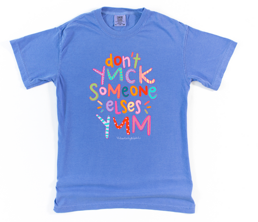 Blue t-shirt with colorful text design on a white background