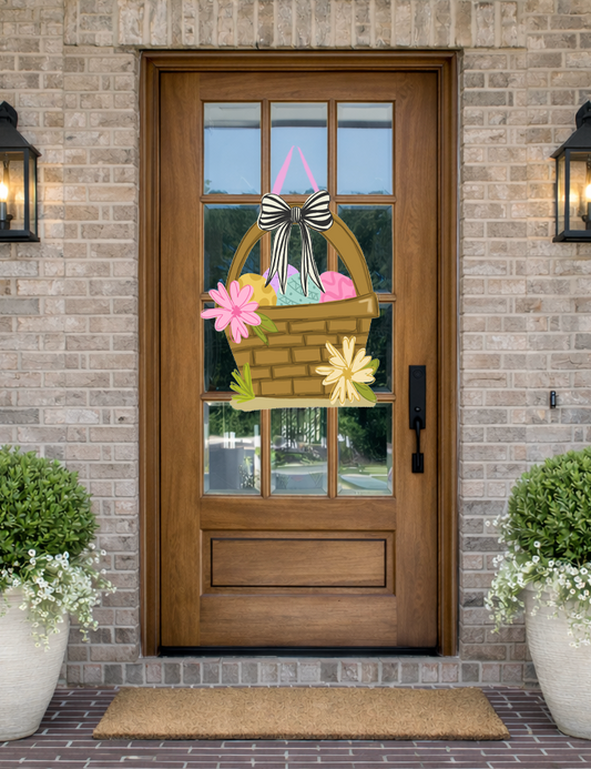 Doodles by Rebekah Easter basket door decor featuring a whimsical hand-painted basket with colorful eggs and a striped bow on a rustic front porch.