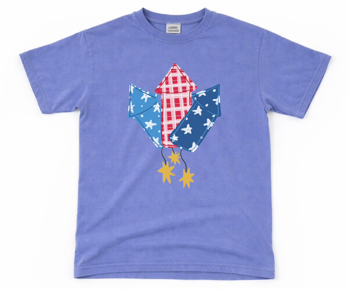 Blue t-shirt with a graphic fireworks on a white background