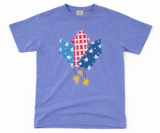 Blue t-shirt with a graphic fireworks on a white background