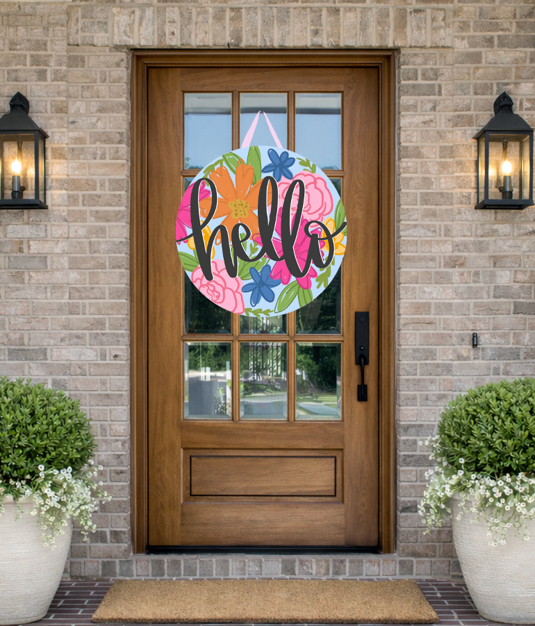 Doodles by Rebekah "Hello" floral door decor featuring a whimsical hand-drawn multi-colored flower pattern on a rustic front porch.