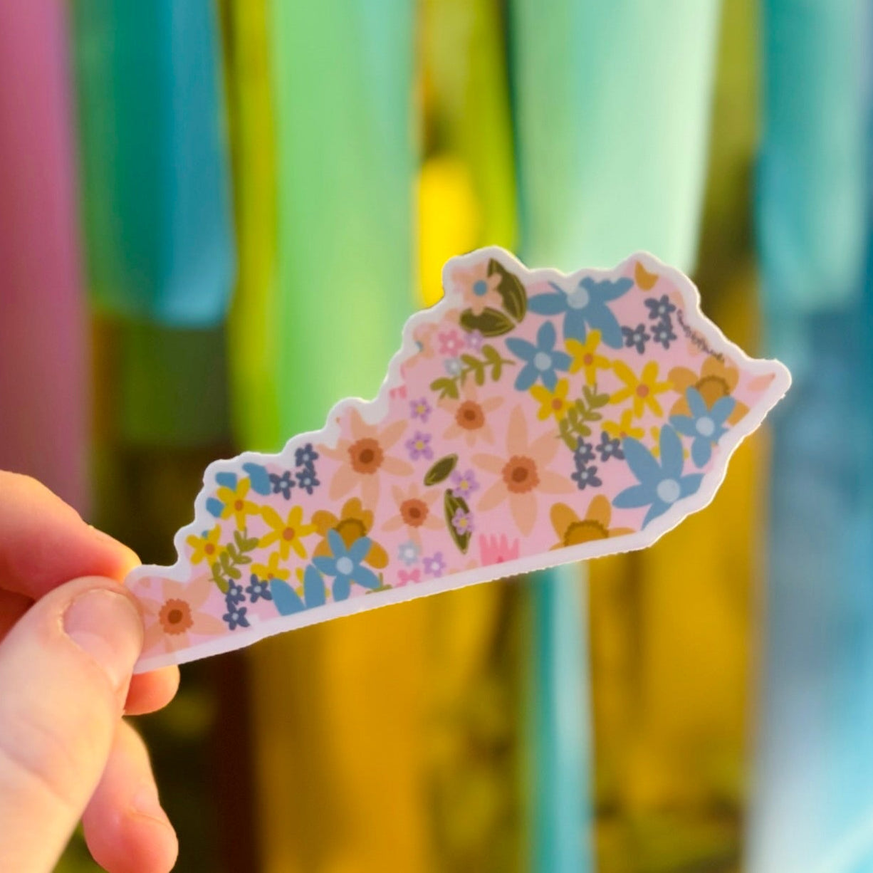 Doodles by Rebekah floral Kentucky state sticker. This whimsical hand-painted vinyl decal features a botanical pattern across the Kentucky map silhouette, making it a perfect gift for Kentucky residents, students, or as a colorful travel souvenir for water bottles and laptops.