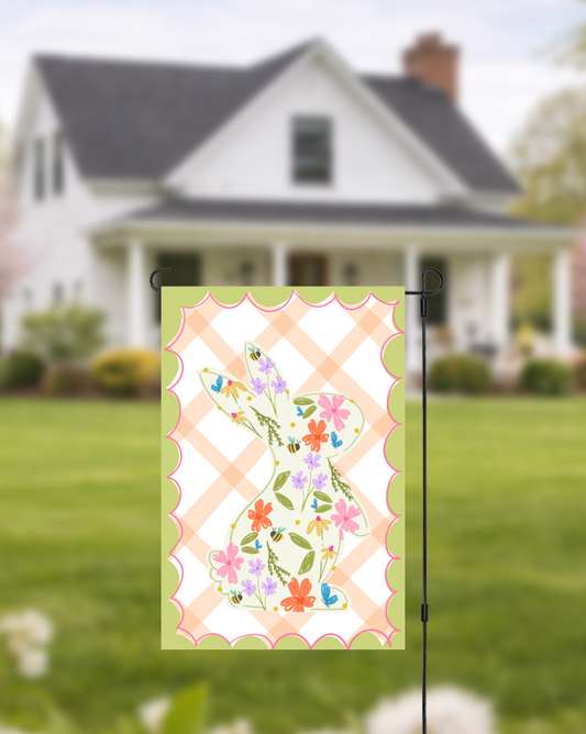 Doodles by Rebekah floral bunny garden flag featuring a whimsical hand-painted rabbit silhouette on an orange checkered background. This vibrant spring outdoor decor is perfect for Easter celebrations or seasonal garden accents.