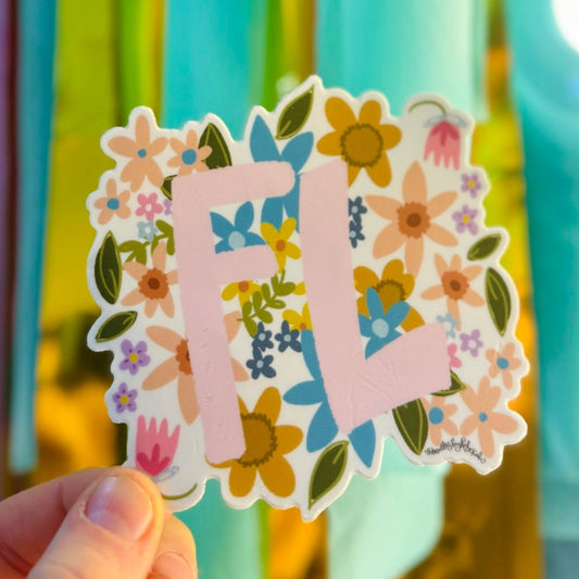 Doodles by Rebekah floral Florida (FL) state abbreviation sticker. This whimsical botanical vinyl decal features a colorful wildflower pattern, making it a perfect sunshine-state gift for decorating water bottles, laptops, and travel journals.