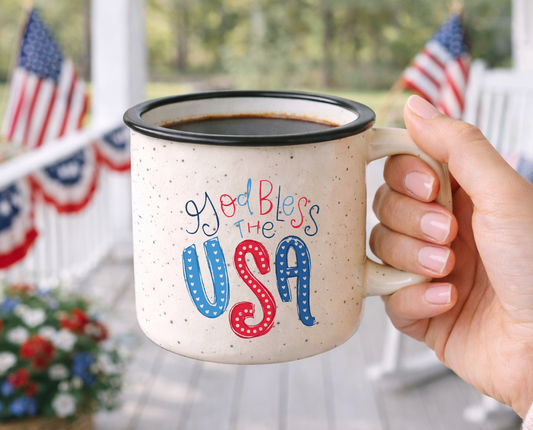 Doodles by Rebekah "God Bless the USA" patriotic mug. This whimsical hand-painted ceramic coffee cup features red, white, and blue Americana typography, making it a perfect gift for the 4th of July, Memorial Day, or patriotic home decor.