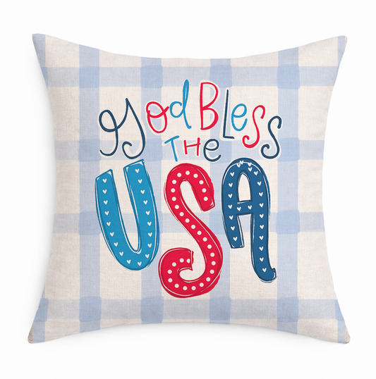 Decorative pillow with 'God Bless The USA' text on a plaid background