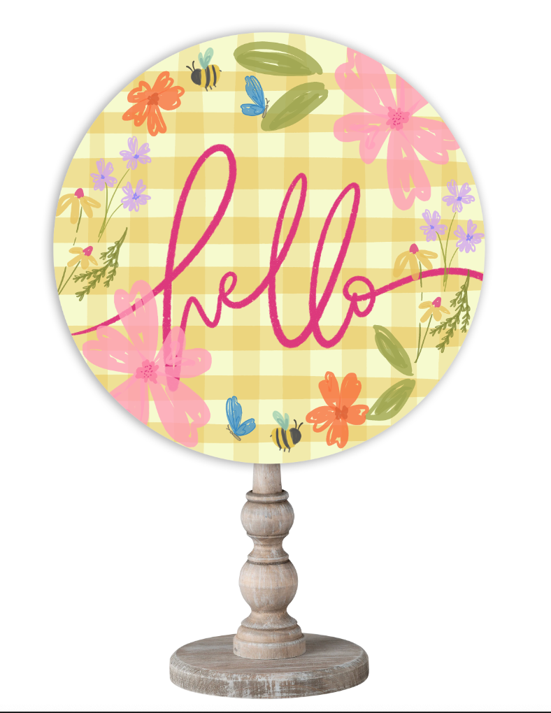 Doodles by Rebekah spring home decor featuring a whimsical floral and bee illustration on a yellow check background with a wooden stand.