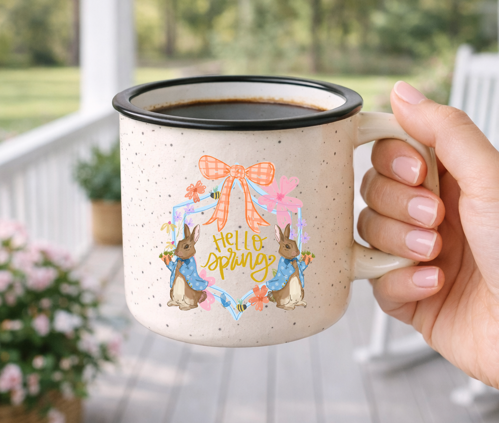 Doodles by Rebekah "Hello Spring" Easter campfire mug. This whimsical hand-painted ceramic coffee cup features charming bunny illustrations and seasonal typography, making it an ideal gift for Easter baskets, spring home decor, or garden lovers.