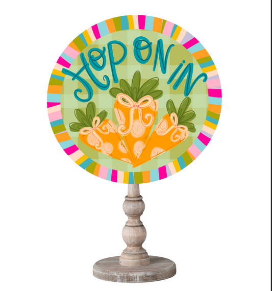 A circular Hop on In Easter Topper with a rainbow border on a wooden dowel and a white background