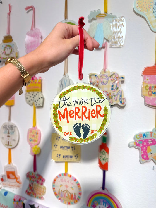 The more the merrier ornament featuring baby feet held by a hand