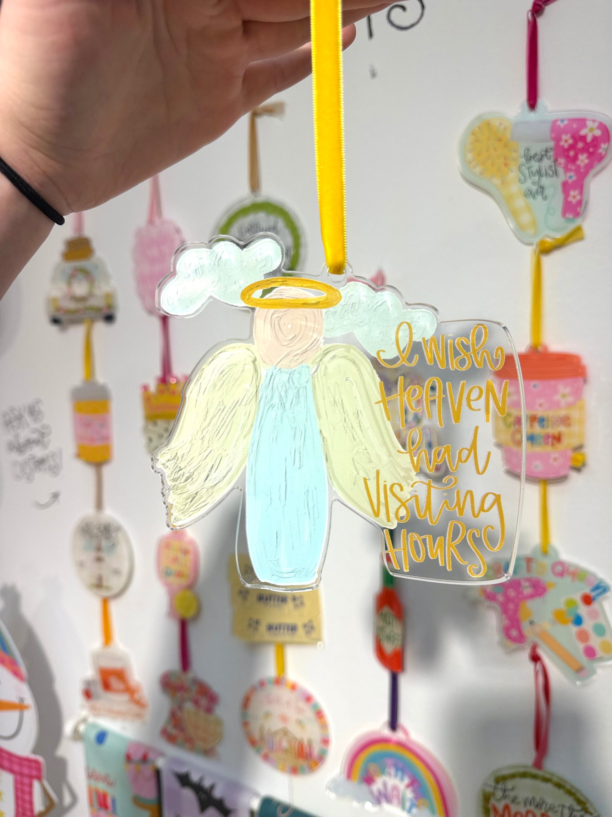 Decorative angel ornament with text on a white background