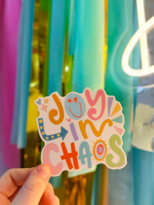 Doodles by Rebekah "JOY IN CHAOS" colorful inspirational sticker. This whimsical hand-painted vinyl decal with a smiley face and sun illustration is a perfect motivational gift for decorating water bottles, laptops, and planners.