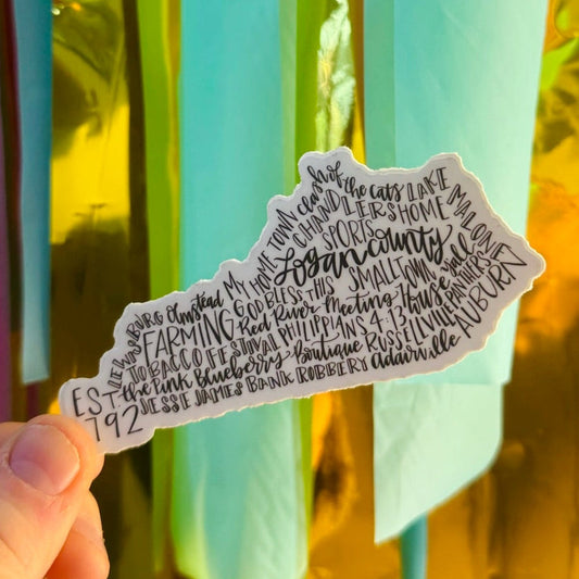 Doodles by Rebekah Logan County, Kentucky state silhouette sticker. This whimsical hand-painted vinyl decal features local KY landmarks and town names in a typography map design, making it a perfect gift for Kentucky residents or a unique souvenir for water bottles and laptops.