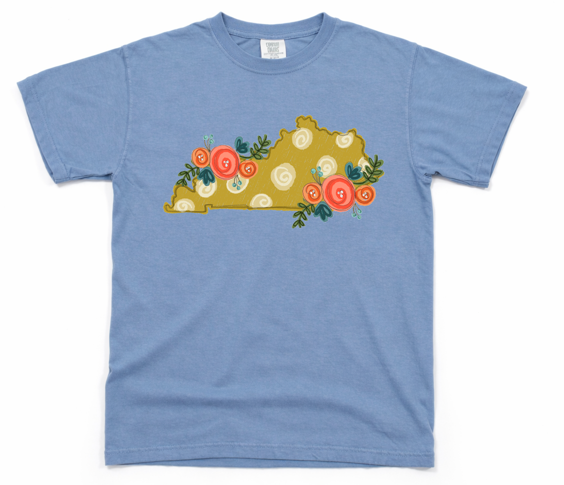 Blue t-shirt with a decorative design of a state map with flowers on a white background