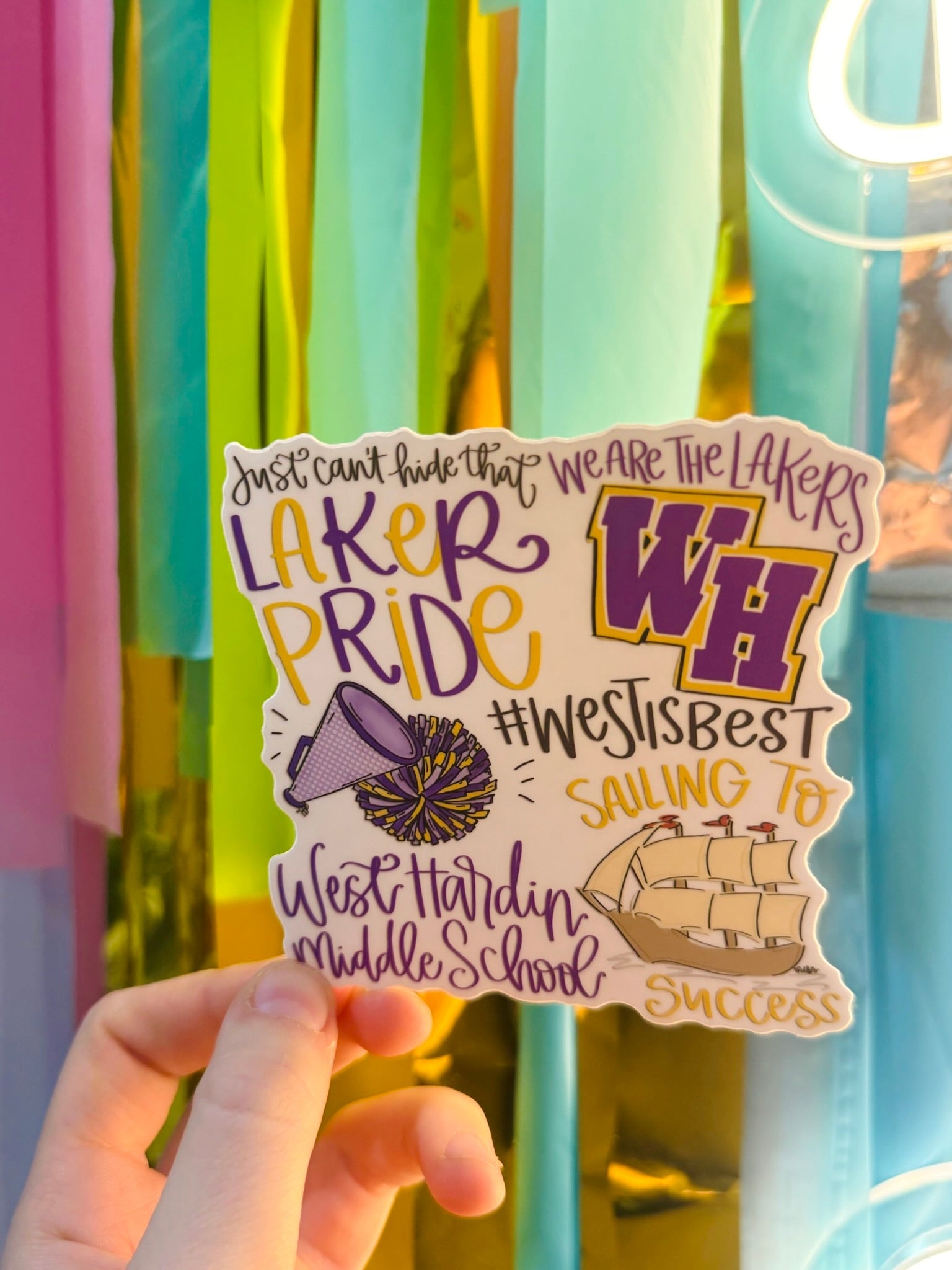 Doodles by Rebekah West Hardin Middle School Laker Pride spirit sticker. This custom hand-painted vinyl decal in purple and gold features school slogans and mascot icons, making it perfect for students and teachers to display on water bottles, laptops, and planners.