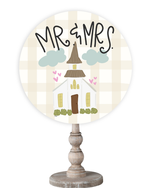 Doodles by Rebekah wedding gift decor featuring a whimsical church illustration and "Mr. & Mrs." hand-lettering on a rustic wooden stand.