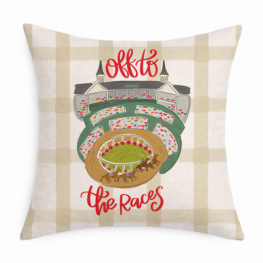 Decorative pillow with a race track illustration and 'Off to the Races' text on a plaid background.