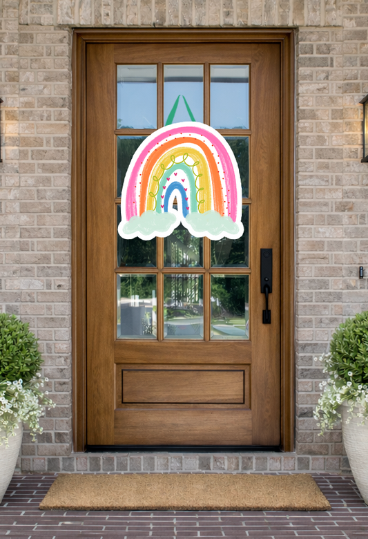 Doodles by Rebekah whimsical rainbow door decor featuring hand-drawn colorful arches and white clouds on a rustic front porch.