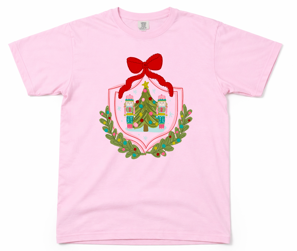 Pink t-shirt with Christmas-themed graphic on a white background